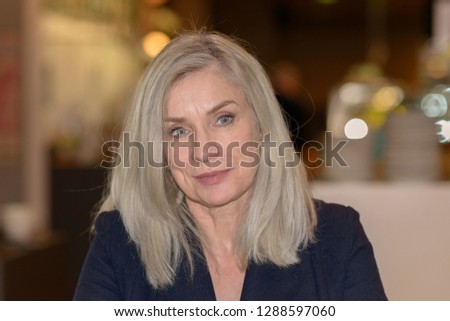 Pensive determined woman in a coffee shop looking to the side