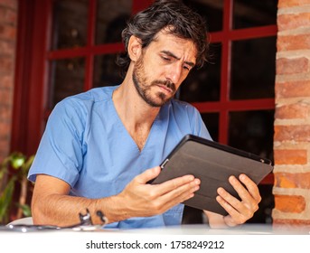 Pensive Doctor With A Tablet In His Hand