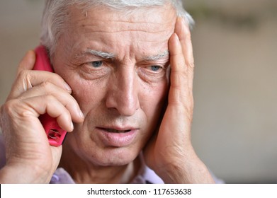 Pensive Elderly Man Calling On The Phone