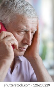 Pensive Elderly Man Calling On The Phone