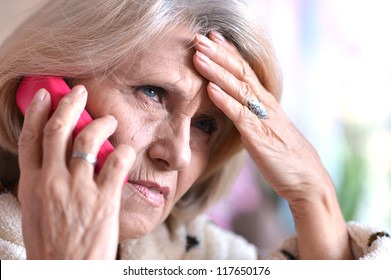 Pensive Elderly Woman Calling On The Phone