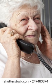 Pensive Elderly Woman Calling On The Phone