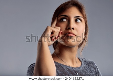 Pensive expression portrayed with a subtle gesture, indicating careful thought or decision-making