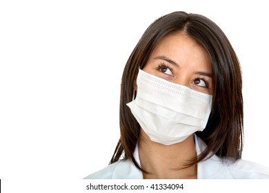 Pensive Female Doctor With Facemask Isolated Over A White Background