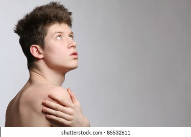 Pensive guy looking at copyspace over grey background