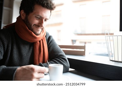 Pensive, happy young man drinking coffee in cafeteria enjoying early morning. Copy space. Lifestyle. - Powered by Shutterstock