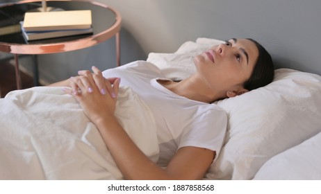 Pensive Latin Woman Laying Awake In Bed 