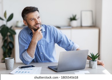Pensive male entrepreneur thinking about something while working at desk in office, found business solution, looking away with pleased face expression - Shutterstock ID 1805545618