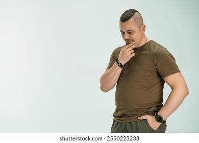 Pensive man in casual clothing contemplating his thoughts. - Powered by Shutterstock