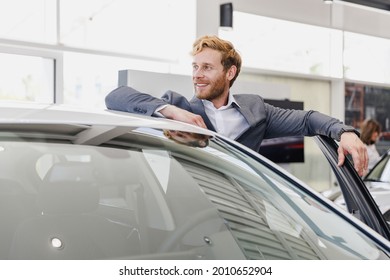 Pensive man customer male buyer businessman client wear classic suit get out car chooses auto wants buy new automobile in showroom vehicle salon dealership store motor show indoor Car sales concept