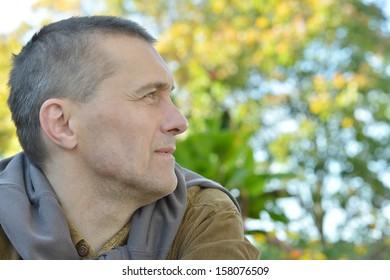 Pensive Man In The Garden In Autumn