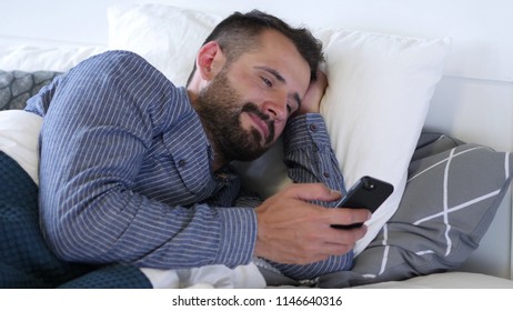 Pensive Man Thinking while Lying on Side in Bed