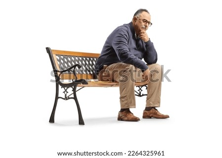 Pensive mature man sitting on a bench and thinking isolated on white background