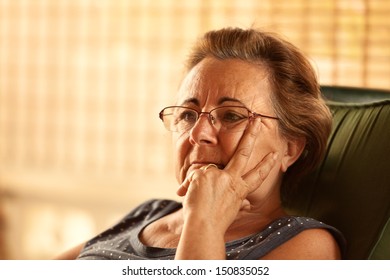 Pensive Mature Woman with Man on Her Face