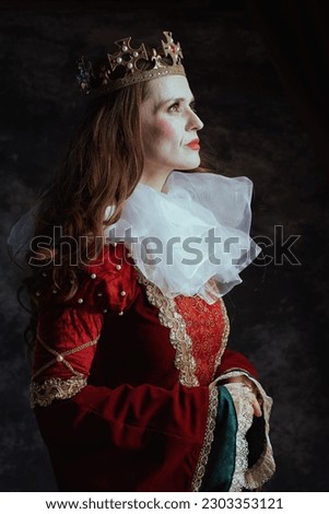 pensive medieval queen in red dress with white collar and crown on dark gray background.