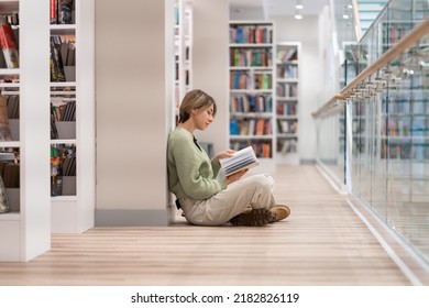 Pensive middle-aged Scandinavian woman book lover spending free leisure time in library, mature female with book in hands sitting in lotus pose on floor near bookcase, enjoying reading. Hobby concept - Shutterstock ID 2182826119