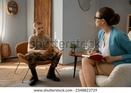 Pensive military man having therapy session with psychologist