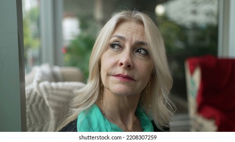 Pensive Older Woman Looking Out Window In Contemplation. Thoughtful Middle Aged Female Businesswoman Thinking Closeup Face Portrait Seated At Coffee Shop