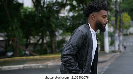 A Pensive Person Walking Outside In Street One Brazilian Man Walks Forward