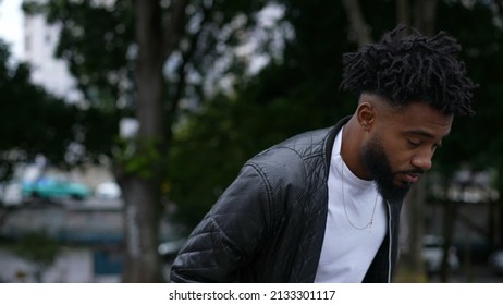 A Pensive Person Walking Outside In Street One Brazilian Man Walks Forward