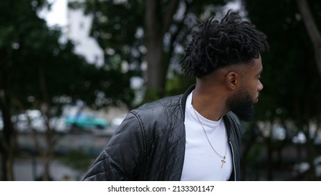 A Pensive Person Walking Outside In Street One Brazilian Man Walks Forward