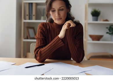 Pensive Pondering Unhappy Sad Curly Beautiful Woman Lost In Heavy Thoughts Looks Down Think About Difficult Life Decision Sitting At Home Office. People Problems Concept