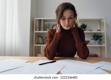 Pensive Pondering Unhappy Sad Curly Beautiful Woman Lost In Heavy Thoughts Looks Down Think About Difficult Life Decision Sitting At Home Office. People Problems Concept