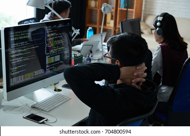 Pensive Programmer Looking At His Code On Computer Screen