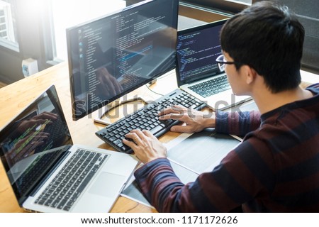Pensive programmer working on on desktop pc programming code technologies or website design at office Software Development Company. 
