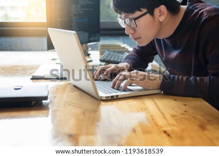 Pensive programmer working on on desktop pc programming code technologies or website design at office Software Development Company. 