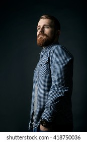 Pensive Red Bearded Man Studio Portrait On Dark Background