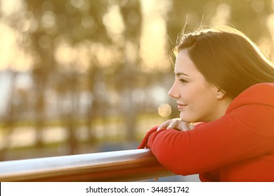 Pensive relaxed girl thinking in winter looking forward at sunset