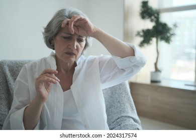 Pensive Sad Senior Middle Aged Grandma Worried Depressed Lonely At Home From Anxiety And Solitude. Close-up Terrified, Disturbed Older Lady Feeling Scared And Thinking Of Sickness Or Mental Health