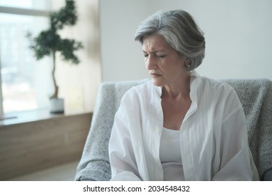 Pensive Sad Senior Middle Aged Grandma Worried Depressed Lonely At Home From Anxiety And Solitude. Close-up Terrified, Disturbed Older Lady Feeling Scared And Thinking Of Sickness Or Mental Health