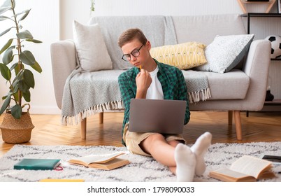 Pensive Schooler Making Essay, Looking At Book, Typing On Laptop At Home, Online Education