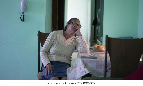 A Pensive Senior Black Woman Sitting Alone At Apartment. A Hispanic Thoughtful Older Person