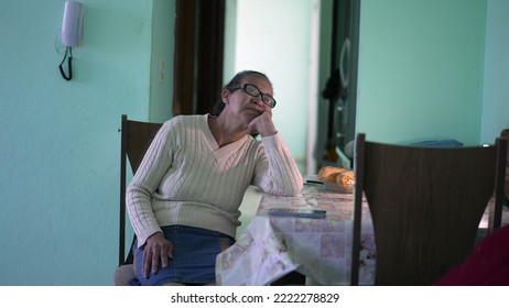 A Pensive Senior Black Woman Sitting Alone At Apartment. A Hispanic Thoughtful Older Person