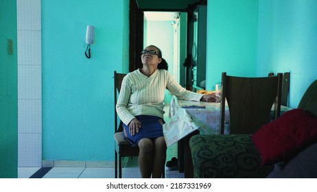 A Pensive Senior Hispanic Woman Sitting At Home Alone. A Thoughtful Black Mature Older Person