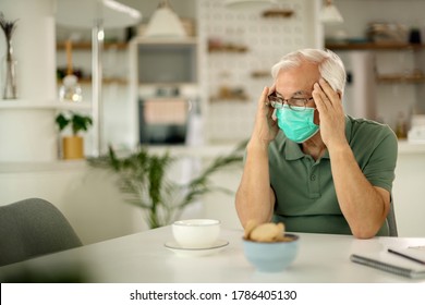 Pensive Senior Man With Face Mask Feeling Worried During Social Isolation Due To Coronavirus Epidemic. 