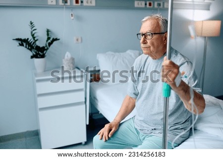 Pensive senior man sitting on hospital bed during his medical recovery.
