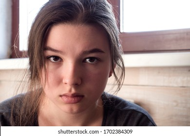 Pensive teen girl at home. Close-up face. Coronavirus quarantine self-isolation concept