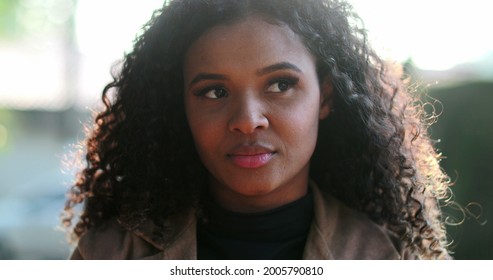 Pensive Thoughtful Black African Woman Thinking Outside Pondering Solution To Problem.