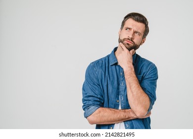 Pensive thoughtful contemplating caucasian young man thinking about future, planning new startup looking upwards isolated in white background