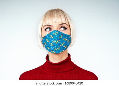 Pensive,  thoughtful woman wearing protection handmade face mask during the quarantine of coronavirus infection outbreak. Copy, empty space for text - Powered by Shutterstock