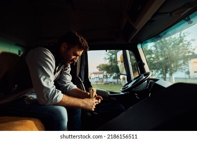 Pensive Truck Driver Eating Sandwich While Sitting Alone In His Cabin.