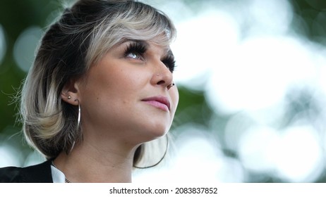 Pensive Woman Looking Up To Sky In Contemplation Outside