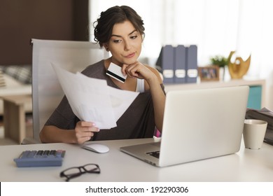 Pensive Woman Paying Bills At Home 