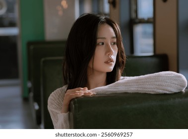 Pensive Woman Sitting in a Sunlit Vintage Train Interior, Exuding Elegance and Thoughtfulness in a Quiet Reflective Moment. - Powered by Shutterstock