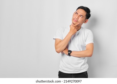 Pensive young Asian man with a serious face thinking about a question, thoughtful about confusing idea isolated on white background - Shutterstock ID 2149270097