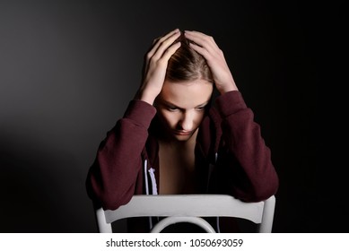  pensive young blond woman in studio - Shutterstock ID 1050693059